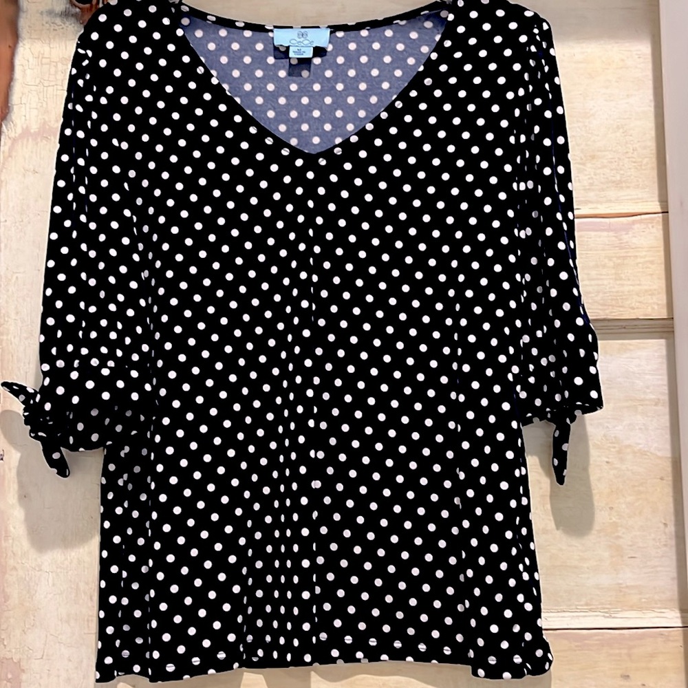 Navy and white polka dot top.